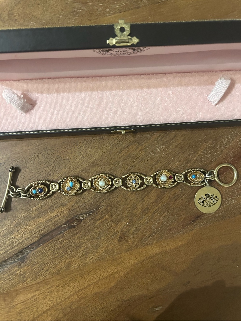 Juicy Couture charm bracelet - has tarnished some by the charm.